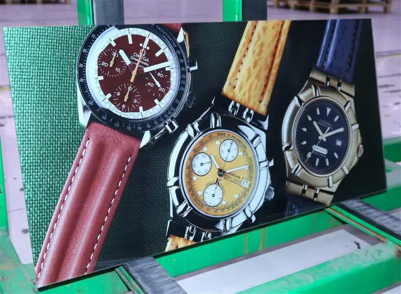 A pane of glass with a vibrant print of watches rests on a palette