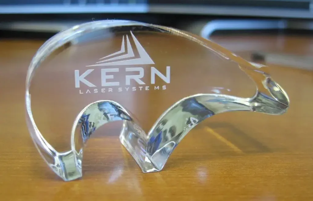 A see-through acrylic polar bear with a logo laser etched into it