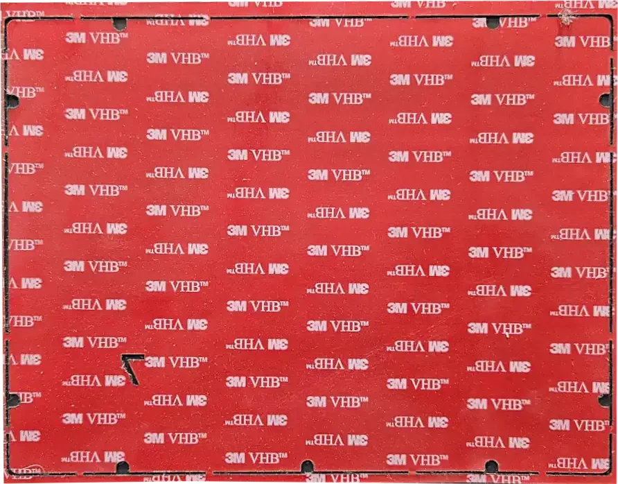 A red panel with a white logo pattern and small sections cut out