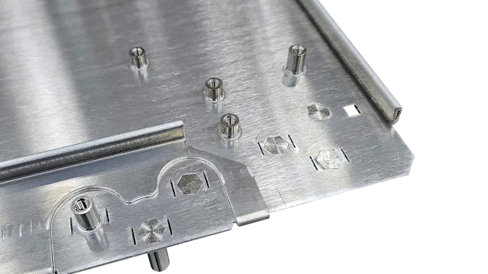 The corner of a sheet of metal that has screw sockets and folds